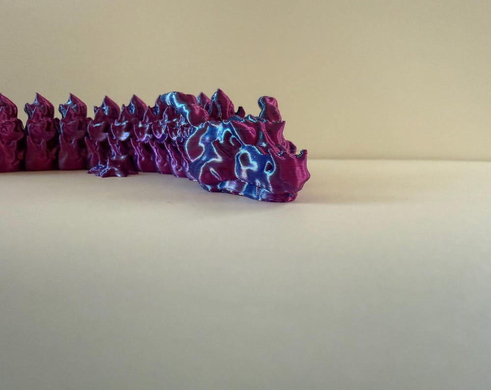 3d-printed” and “articulated dragon” are likely search terms.