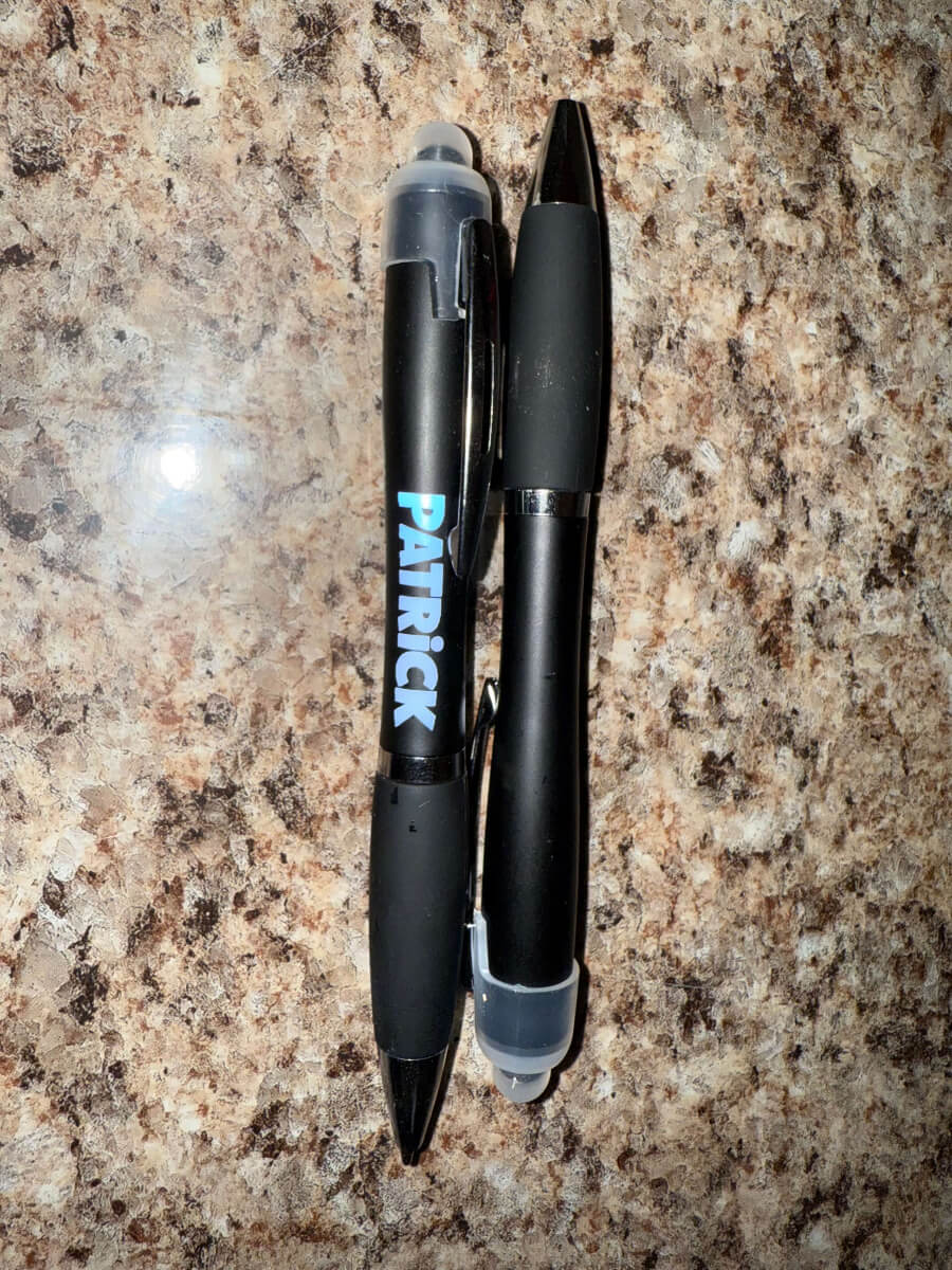 Black 3-in-1 stylus pen with custom engraved logo, featuring a ballpoint tip, LED light, and touchscreen stylus – perfect for business promotions and personalized gifts